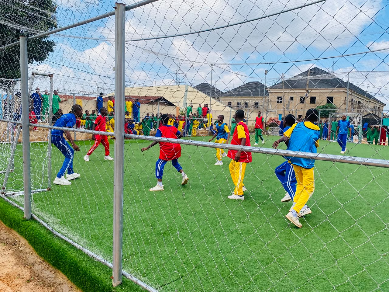 Vonschools students in colourful team uniforms playing a court sport