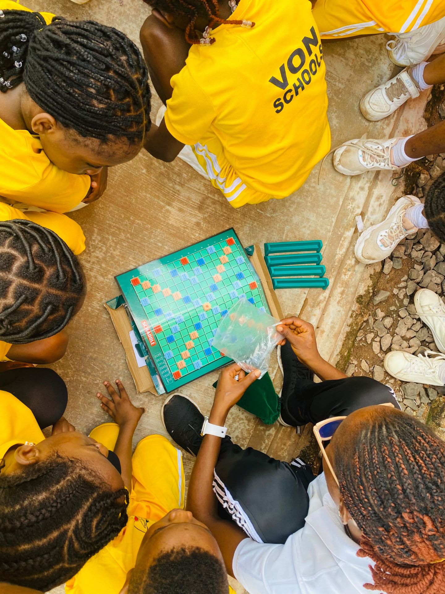 Vonschools students playing Scrabble outdoors