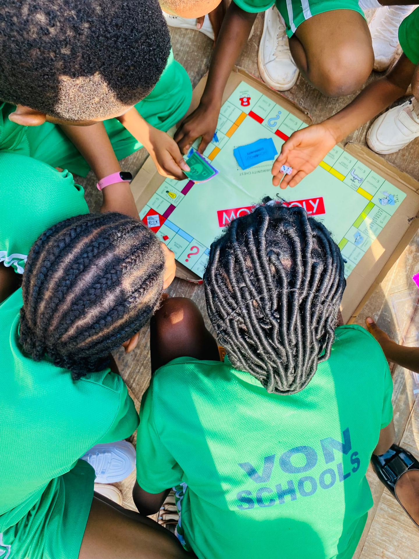 Vonschools students playing Monopoly together